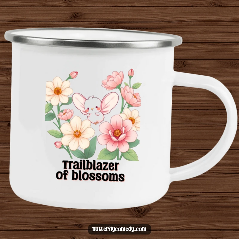 Funny camping mug showing a small, fluffy creature with large wings, fluttering enthusiastically amongst oversized, colorful flowers.