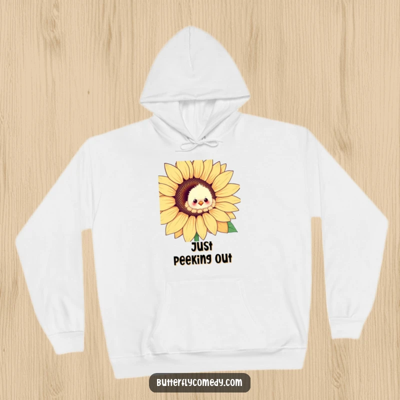 Funny chick peeking out playfully from a large sunflower petal, designed for a cozy and humorous hoodie.