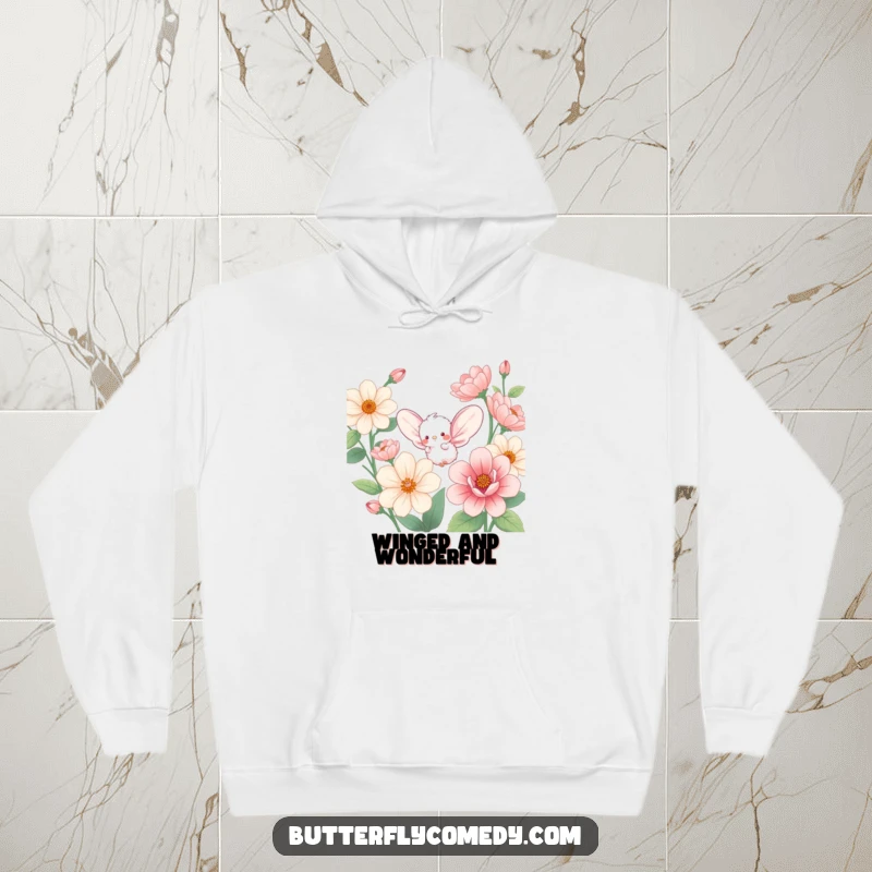 Funny hoodie featuring a small, fluffy creature with expansive wings, enthusiastically fluttering through a field of giant, blooming flowers.