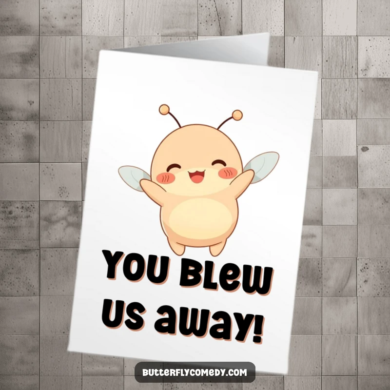 Funny free printable congratulations card showing a plump creature with antennae wiggling joyfully while being lifted by a breeze.